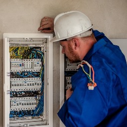 London AR electrician inspecting circuit panel